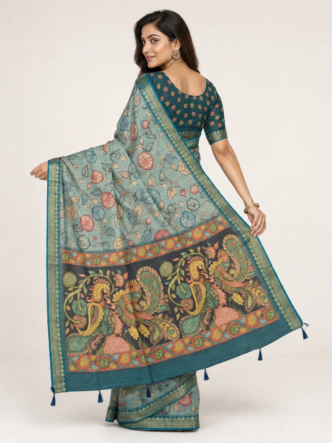 back view of sea green kalamkari saree showing peacock pallu and teal blouse