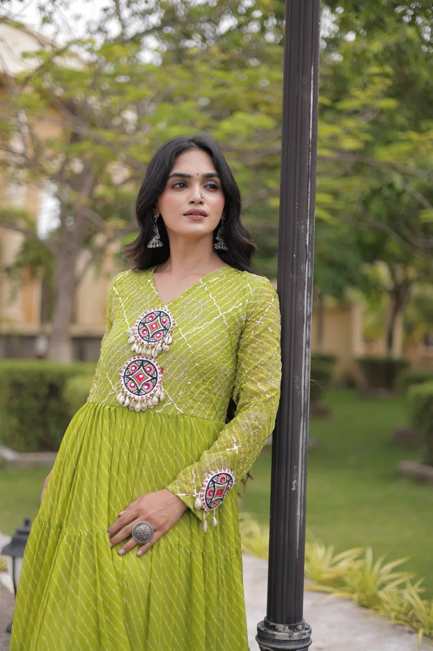 green sequin leheriya gown with dual kutchi mirror medallions and cowrie tassels