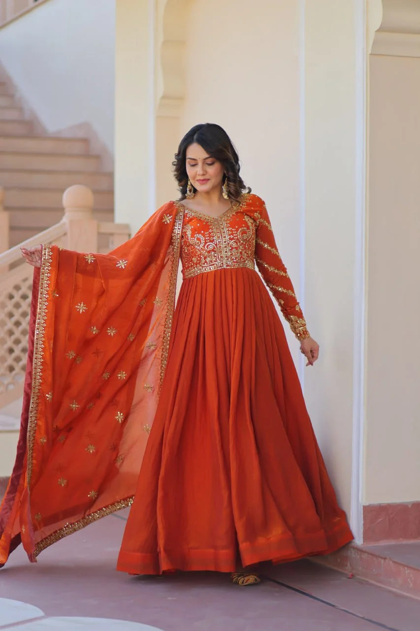 rust orange silk gown closeup with flying gold buti dupatta