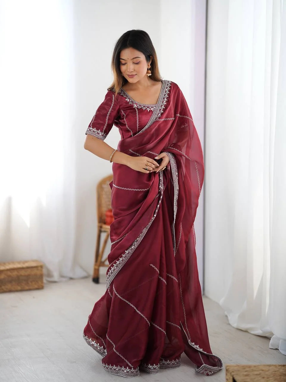 Maroon JMC silk saree — elegant standing pose with silver sequin thread embroidery