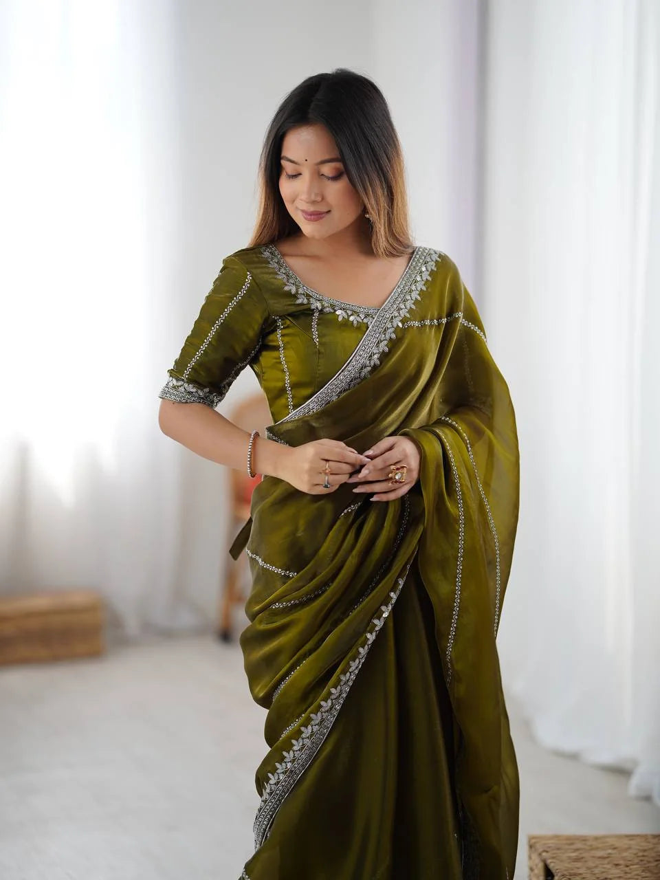 Olive green silk saree with thread and sequin work — confident full pose Chicora Wear