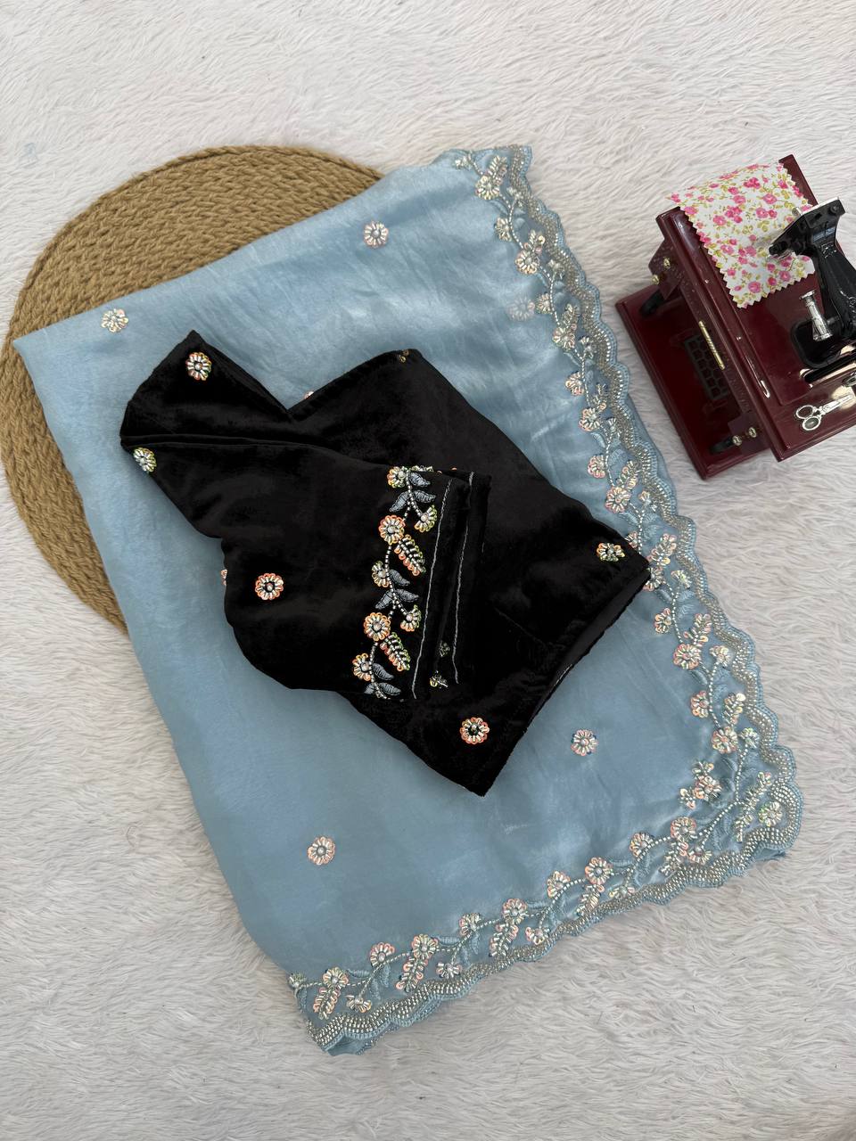 Draped view of sky blue Fendy silk saree with elegant embroidered border