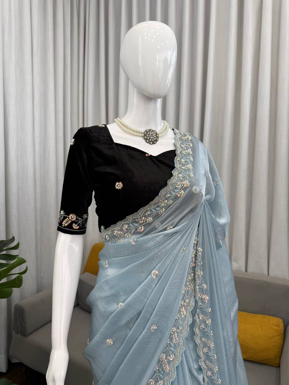Styled look of sky blue Fendy silk saree with sequence work and velvet blouse