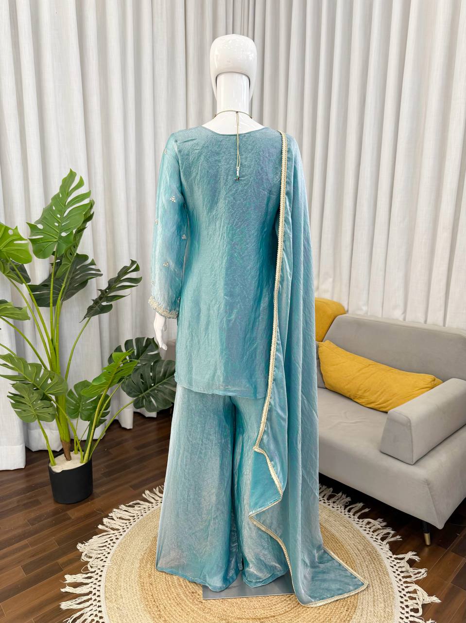Back view of teal kurta palazzo set with dupatta for traditional and festive occasions