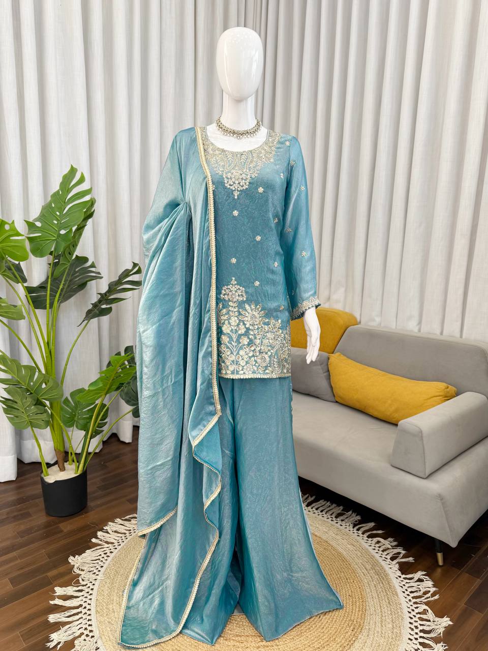 Teal green kurta palazzo set on mannequin with dupatta and embroidery for festive wear