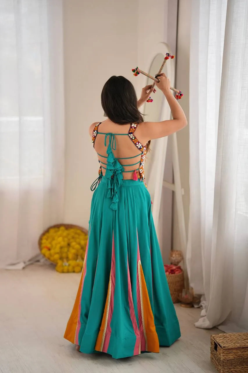Strappy tie-back of teal navratri chaniya choli with multicolour mirror-work choli — back view