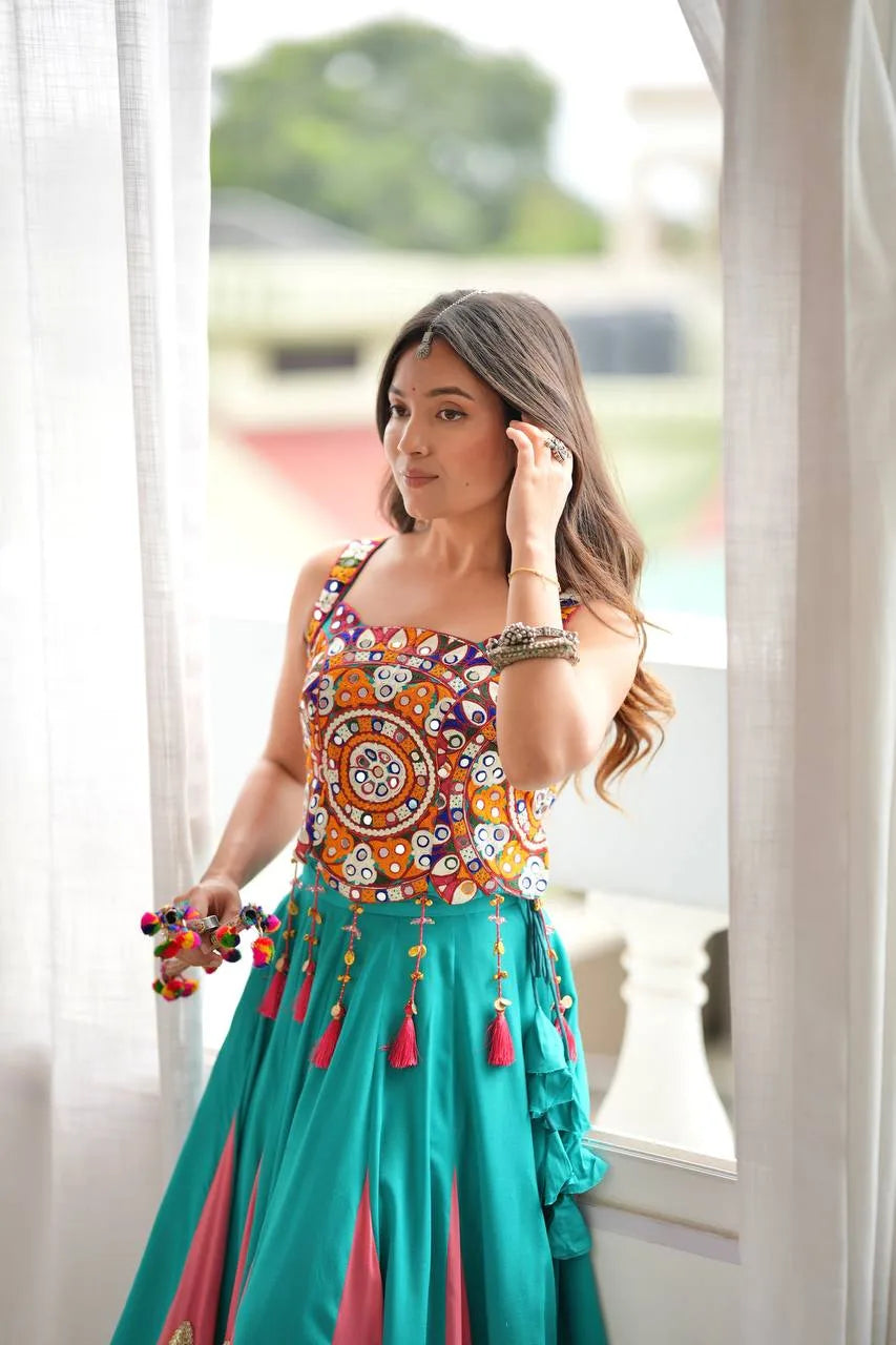 Multicolour Kutchi mirror-work choli of teal navratri chaniya choli with maroon latkan tassels — front detail