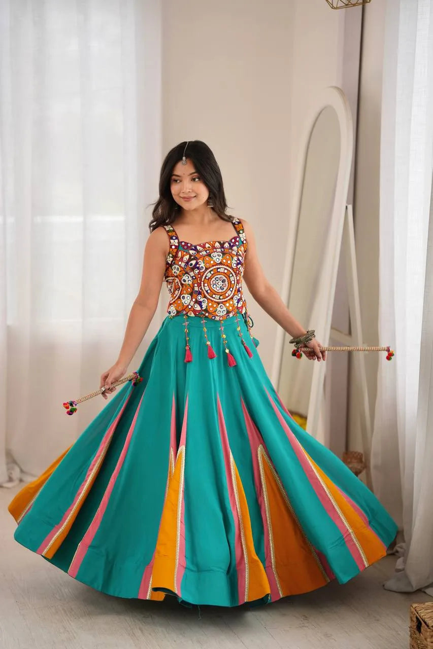 Teal navratri chaniya choli spinning to show 6-metre garba flair with orange and pink kali gores — twirl view