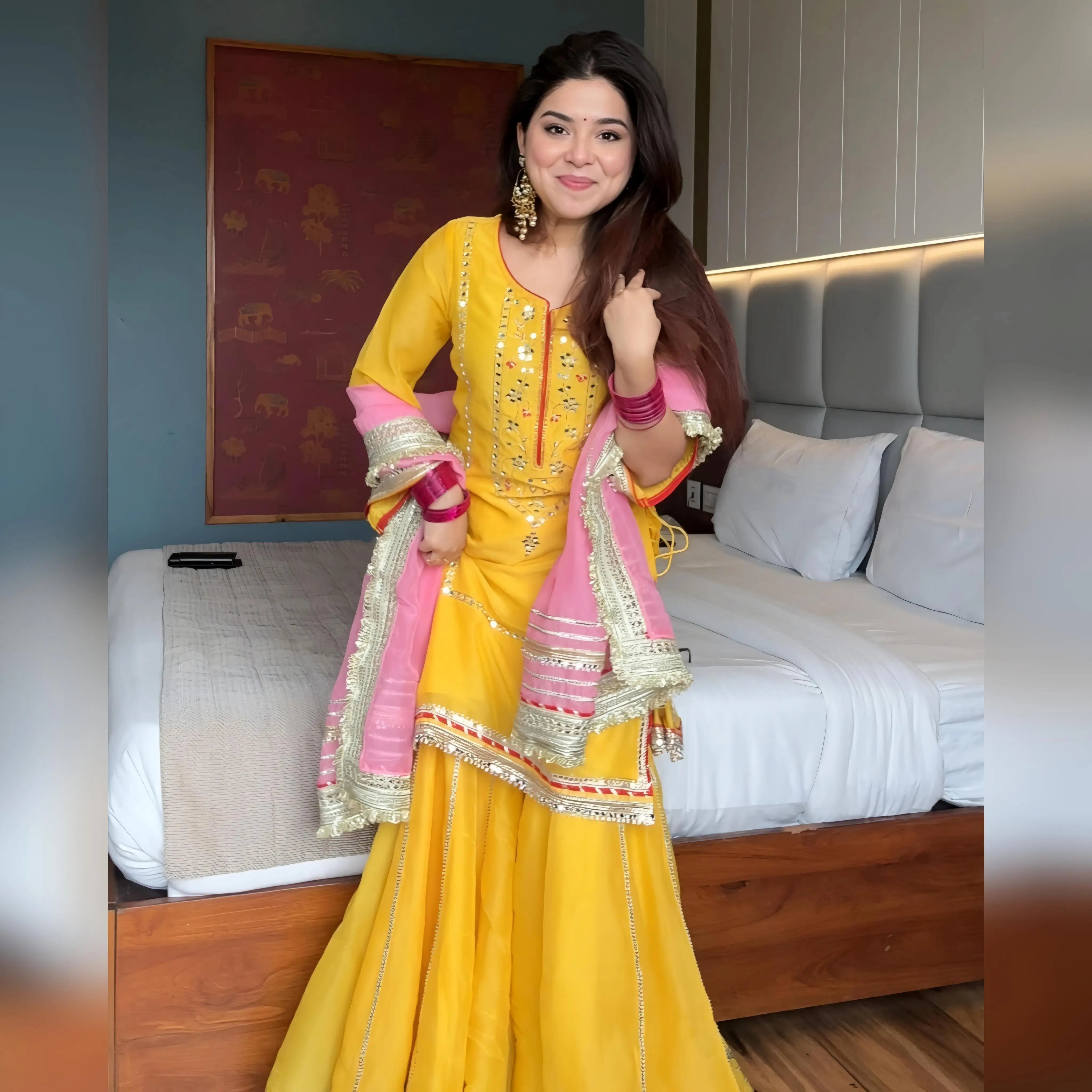 Full front view of yellow chinon silk sharara set with mirror embroidery and pink gota patti dupatta