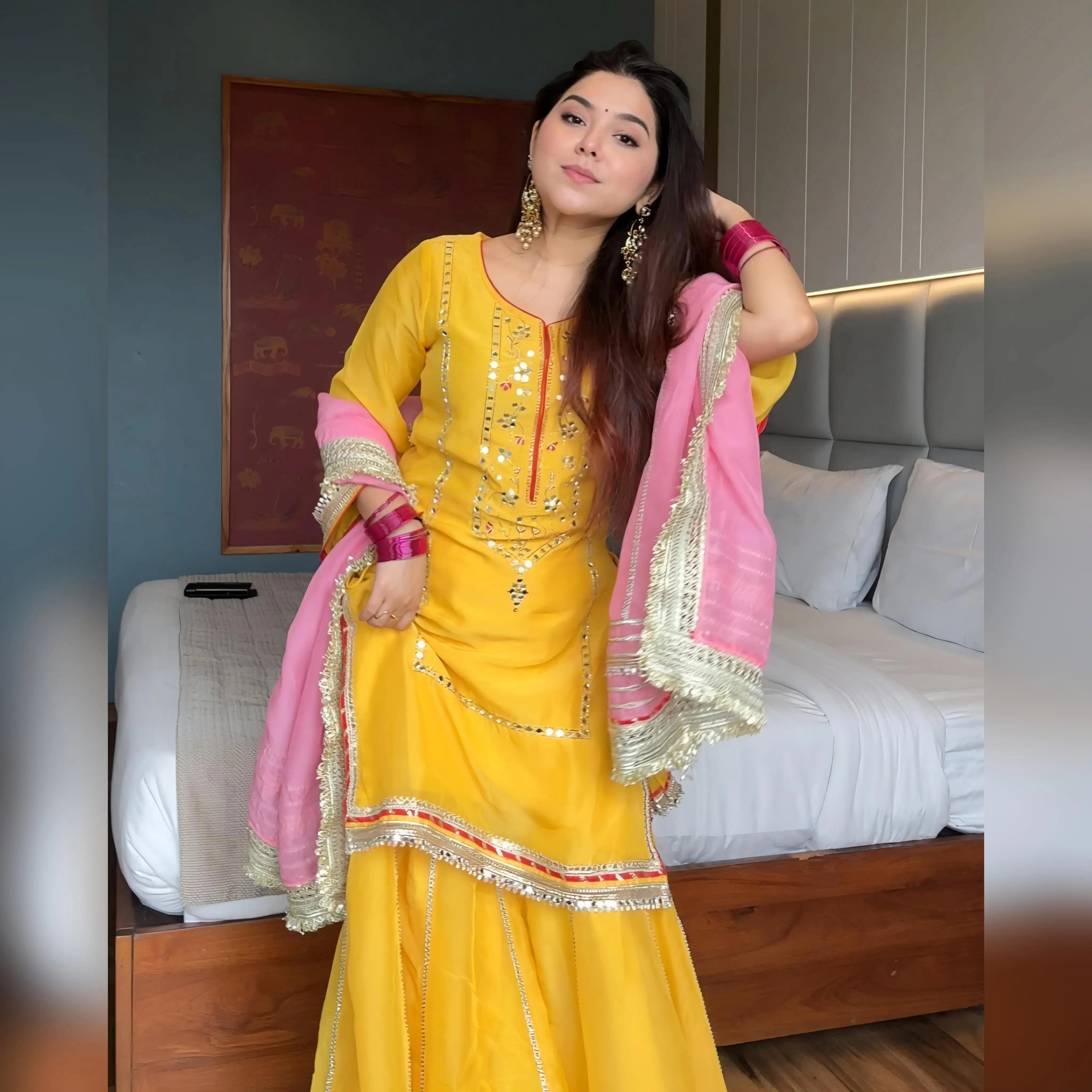 Kurti closeup of yellow chinon silk sharara set showing shisha mirror work and gota patti embroidery
